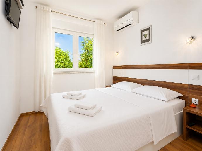 Double bedroom with en suite bathroom, A/C, and TV . - Villa Krnica . (Photo Gallery) }}