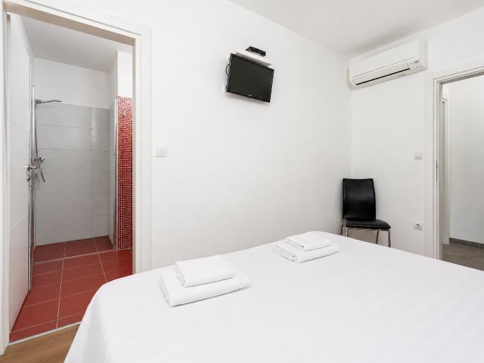 Double bedroom with en suite bathroom, A/C, and TV . - Villa Krnica . (Photo Gallery) }}