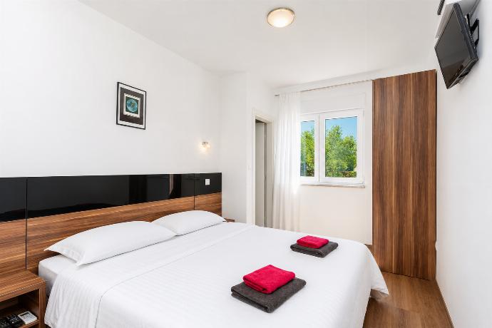 Double bedroom with en suite bathroom, A/C, and TV . - Villa Krnica . (Photo Gallery) }}
