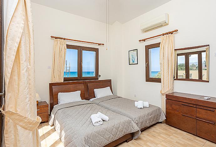 Twin bedroom with en suite bathroom, A/C, and upper terrace access . - Villa Tsikkos Ena . (Photo Gallery) }}