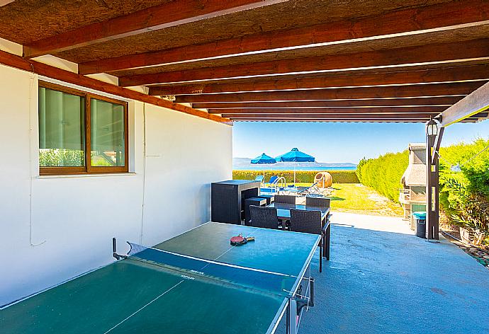 Sheltered terrace area with table tennis . - Blue Bay Villa Dimitris . (Photo Gallery) }}
