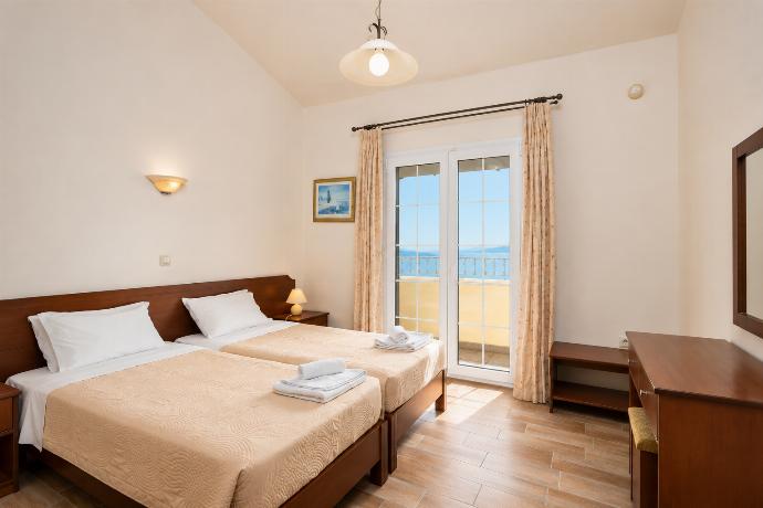 Twin bedroom on second floor with A/C, sea views, and balcony access . - Ioannas House . (Photo Gallery) }}