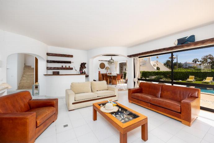 Living room with sofas, dining area, ornamental fireplace, A/C, WiFi internet, and satellite TV . - Villa Veiguinha . (Photo Gallery) }}
