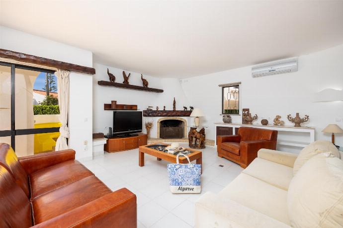 Living room with sofas, dining area, ornamental fireplace, A/C, WiFi internet, and satellite TV . - Villa Veiguinha . (Photo Gallery) }}