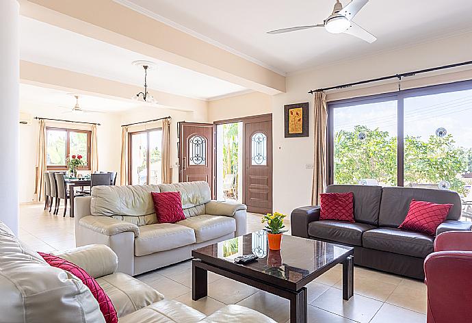 Open-plan living room with sofas, dining area, kitchen, ornamental fireplace, A/C, WiFi internet, and satellite TV . - Villa Dora . (Galerie de photos) }}