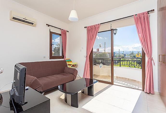 Living area on first floor with sofa, A/C, TV, and balcony access . - Villa Dora . (Galleria fotografica) }}