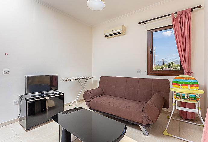 Living area on first floor with sofa, A/C, TV, and balcony access . - Villa Dora . (Galerie de photos) }}