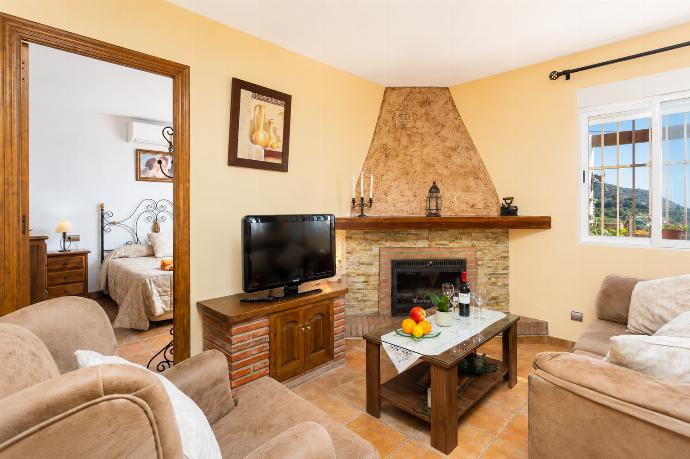 Open-plan living room with sofas, dining area, kitchen, ornamental fireplace, WiFi internet, satellite TV, and sea views . - Villa Ana y Garcia . (Photo Gallery) }}