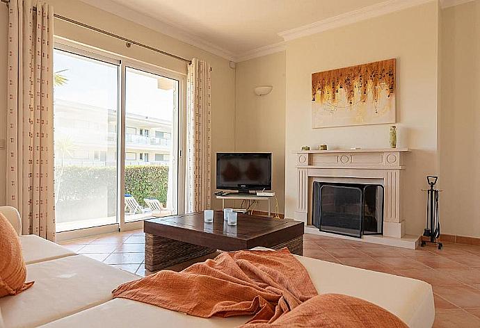 Living room with comfortable sofa, TV and ornamental fire place . - Villa Costa . (Photo Gallery) }}
