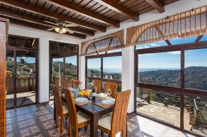 Open-plan living room with sofas, dining area, kitchen, ornamental fireplace, A/C, WiFi internet, satellite TV, and sea views . - Villa Cortijo El Amigo . (Photo Gallery) }}