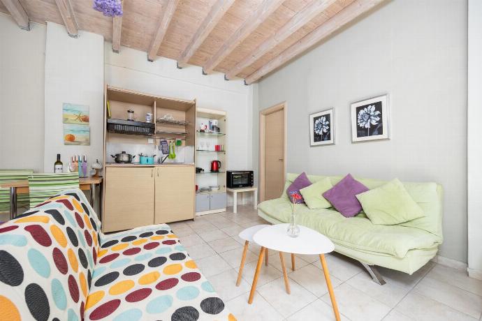 Open-plan living room with sofas, dining area, kitchen, A/C, WiFi internet, and satellite TV . - Niki Studio Tria . (Photo Gallery) }}