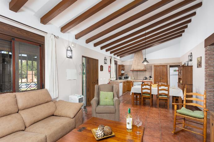 Open-plan living room with sofa, dining area, kitchen, ornamental fireplace, WiFi internet, and satellite TV . - Villa Loli Imaroga One . (Photo Gallery) }}