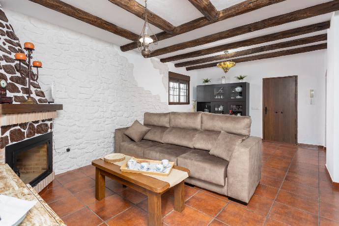 Living room with sofa, dining area, ornamental fireplace, WiFi internet, and satellite TV . - Villa Cortijo Romero . (Galerie de photos) }}