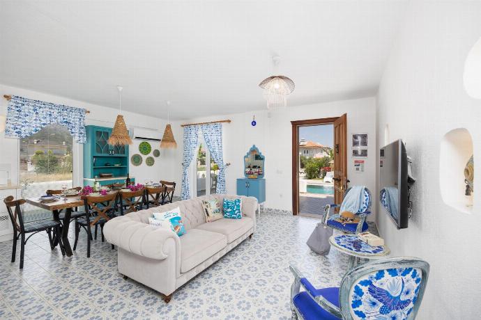 Open-plan living room with sofa, dining area, kitchen, A/C, WiFi internet, and satellite TV . - Villa Blue Island . (Photo Gallery) }}
