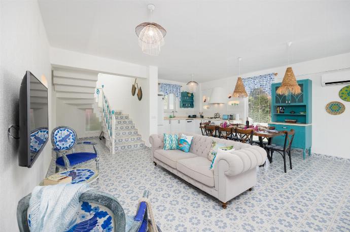 Open-plan living room with sofa, dining area, kitchen, A/C, WiFi internet, and satellite TV . - Villa Blue Island . (Photo Gallery) }}
