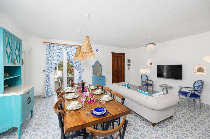 Open-plan living room with sofa, dining area, kitchen, A/C, WiFi internet, and satellite TV . - Villa Blue Island . (Photo Gallery) }}