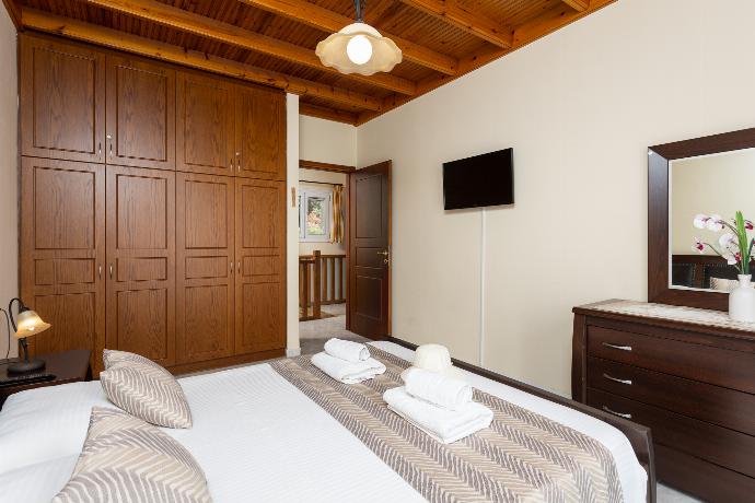 Double bedroom on first floor with TV, sea views, and balcony access . - Villa Sunrise . (Photo Gallery) }}