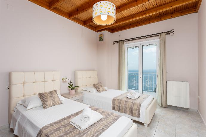 Twin bedroom on first floor with sea views and balcony access . - Villa Sunrise . (Photo Gallery) }}