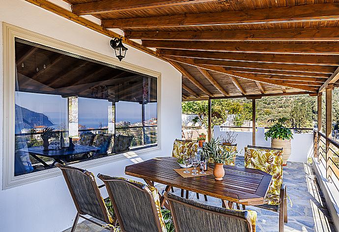 Terrace with dining table and sea view  . - Villa Aloupi . (Photo Gallery) }}