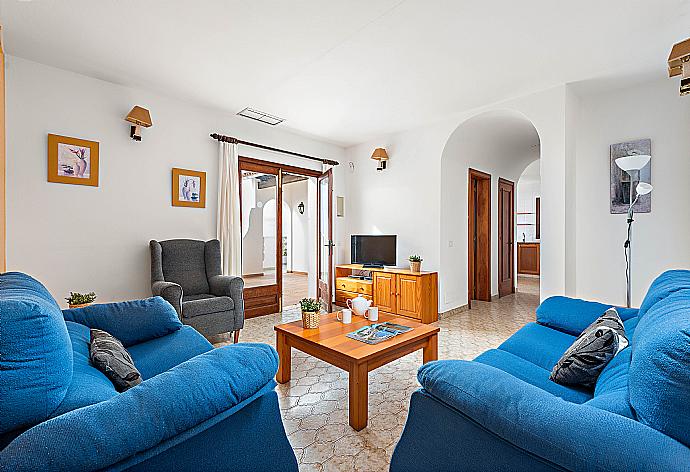 Living room area with A/C, sofas, Satellite Tv . - Villa Castellet . (Photo Gallery) }}