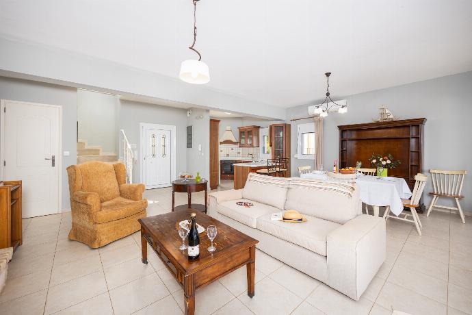 Open-plan living room with sofa, dining area, kitchen, ornamental fireplace, A/C, WiFi internet, and satellite TV . - Villa Chloe . (Photo Gallery) }}