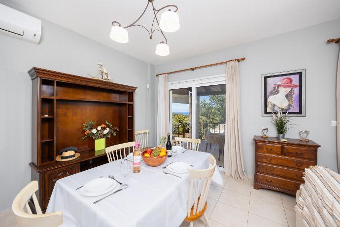 Open-plan living room with sofa, dining area, kitchen, ornamental fireplace, A/C, WiFi internet, and satellite TV . - Villa Chloe . (Photo Gallery) }}