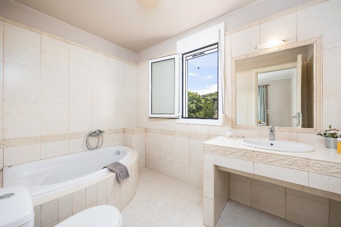 En suite bathroom with bath and shower . - Villa Chloe . (Photo Gallery) }}