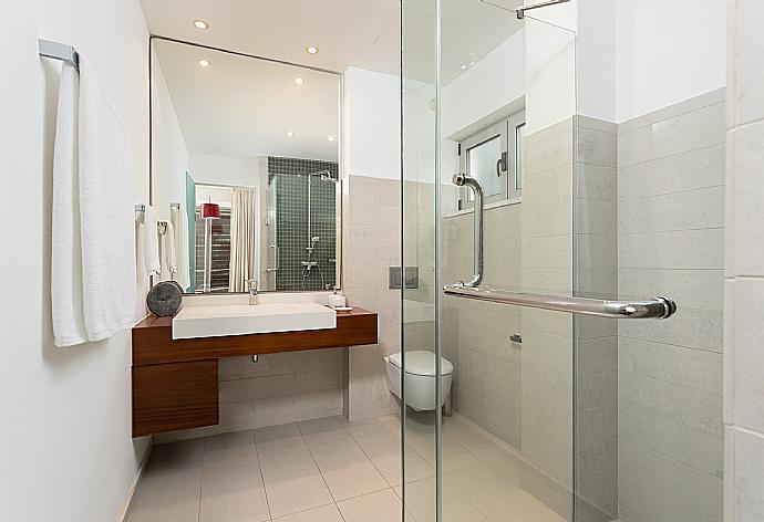 En suite bathroom with shower . - Annabel Beach Palace . (Photo Gallery) }}