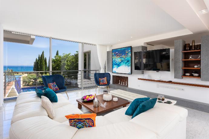 Open-plan living room on first floor with sofa, dining area, kitchen, ornamental fireplace, A/C, WiFi internet, satellite TV, and sea views . - Annabel Beach Palace . (Fotogalerie) }}