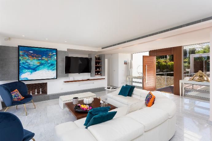 Open-plan living room on first floor with sofa, dining area, kitchen, ornamental fireplace, A/C, WiFi internet, satellite TV, and sea views . - Annabel Beach Palace . (Photo Gallery) }}