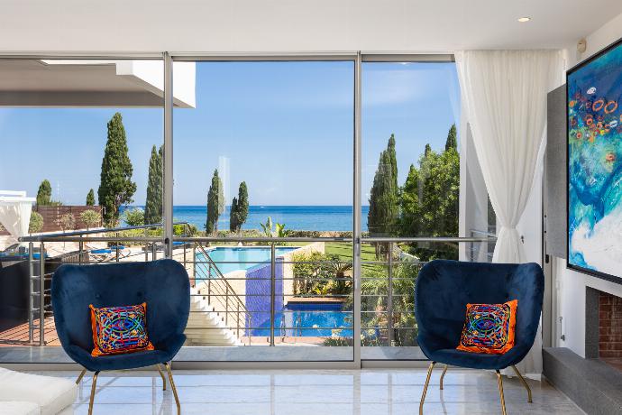 Open-plan living room on first floor with sofa, dining area, kitchen, ornamental fireplace, A/C, WiFi internet, satellite TV, and sea views . - Annabel Beach Palace . (Galleria fotografica) }}