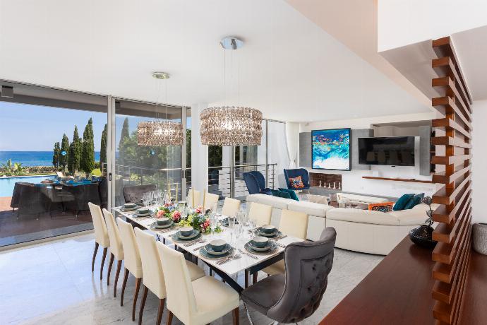 Open-plan living room on first floor with sofa, dining area, kitchen, ornamental fireplace, A/C, WiFi internet, satellite TV, and sea views . - Annabel Beach Palace . (Fotogalerie) }}