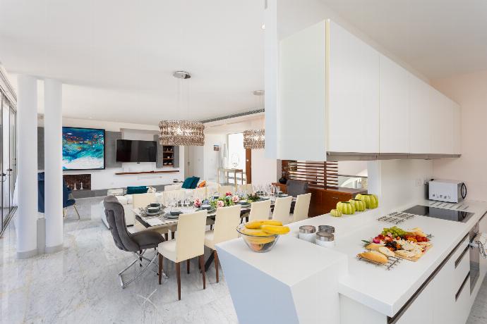 Open-plan living room on first floor with sofa, dining area, kitchen, ornamental fireplace, A/C, WiFi internet, satellite TV, and sea views . - Annabel Beach Palace . (Fotogalerie) }}