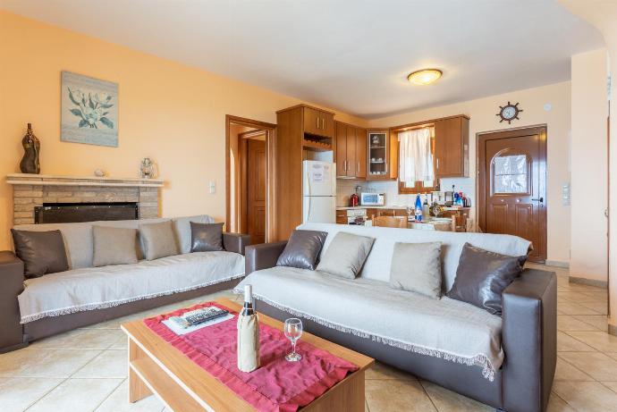 Open-plan living room with sofas, dining area, kitchen, A/C, WiFi internet, satellite TV, sea views, and terrace access . - Fiscardo Villas Collection . (Fotogalerie) }}