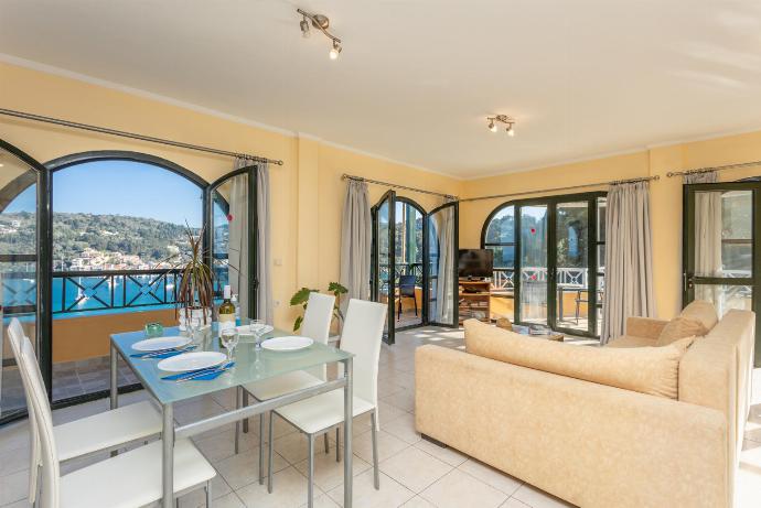 Open-plan living room with sofa, dining area, kitchen, A/C, WiFi internet, satellite TV, sea views, and terrace access . - Lakka Bay View Collection . (Galleria fotografica) }}