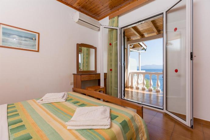 Double bedroom with A/C and balcony access . - Dolphin Villas Collection . (Galleria fotografica) }}