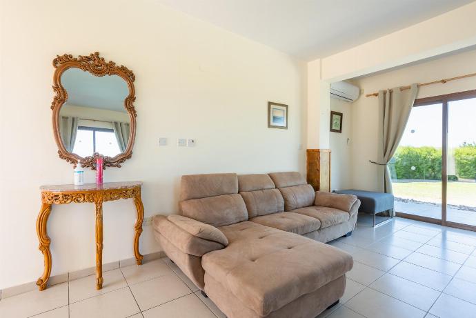 Open-plan living room with sofas, dining area, kitchen, ornamental fireplace, A/C, WiFi internet, satellite TV, and sea views . - Blue Bay Villas Collection . (Галерея фотографий) }}