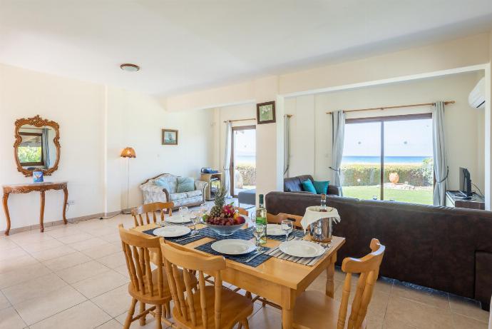 Open-plan living room with sofas, dining area, kitchen, ornamental fireplace, A/C, WiFi internet, satellite TV, and sea views . - Blue Bay Villas Collection . (Галерея фотографий) }}