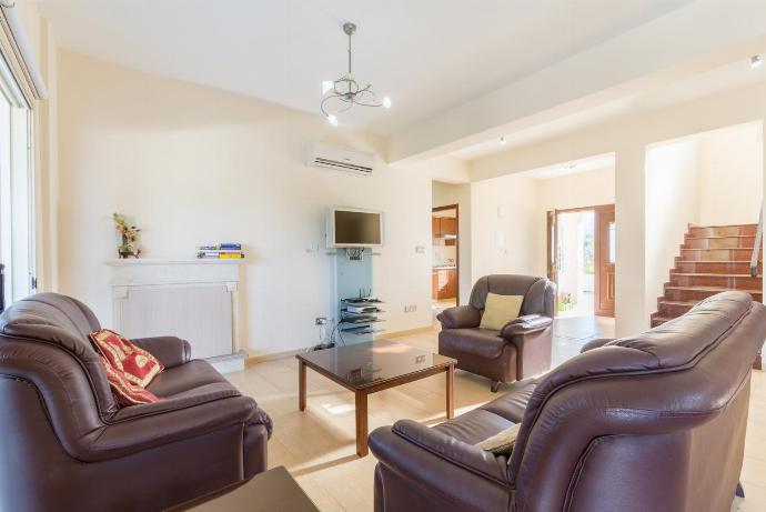 Open-plan living room with sofas, dining area, kitchen, ornamental fireplace, A/C, WiFi internet, and satellite TV . - Rose Villas Collection . (Galería de imágenes) }}