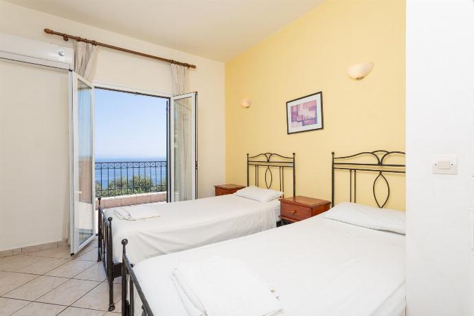 Twin bedroom with A/C and balcony access . - Nissaki Villas Collection . (Galería de imágenes) }}