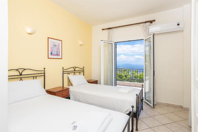 Twin bedroom with A/C and upper terrace access with sea views . - Nissaki Villas Collection . (Fotogalerie) }}