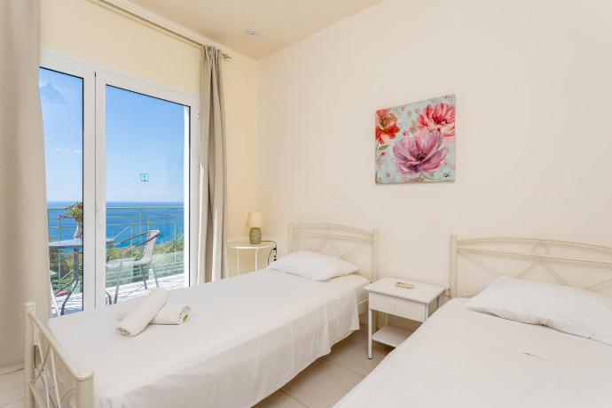 Twin bedroom with en suite bathroom, A/C, and upper terrace access with panoramic sea views . - Lourdas Villas Collection . (Fotogalerie) }}