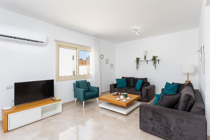 Open-plan living room with sofas, dining area, kitchen, A/C, WiFi internet, satellite TV, and sea views . - Villa Diana Seaside . (Photo Gallery) }}