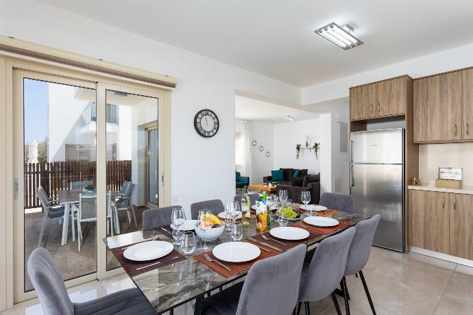 Open-plan living room with sofas, dining area, kitchen, A/C, WiFi internet, satellite TV, and sea views . - Villa Diana Seaside . (Photo Gallery) }}