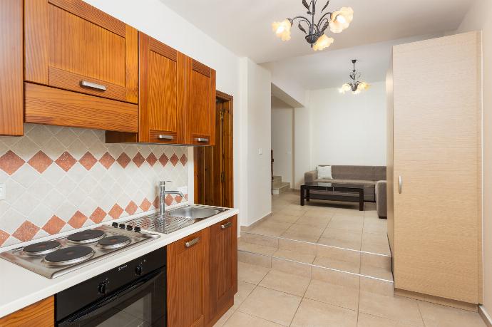Living area with sofa and kitchenette  . - Villa Elounda Plaka . (Photo Gallery) }}