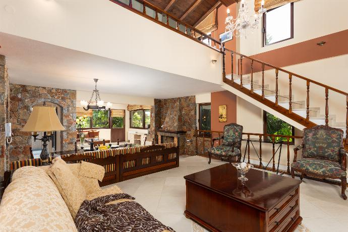 Open-plan living room with sofas, dining area, kitchen, ornamental fireplace, A/C, WiFi internet, and satellite TV . - Villa Elounda Blue . (Photo Gallery) }}