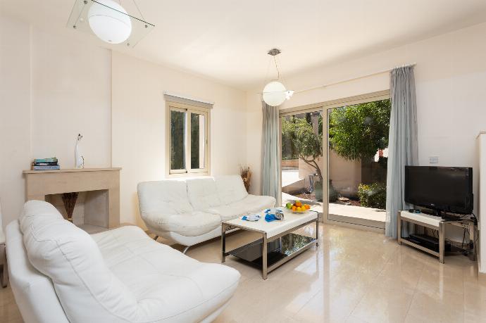 Open-plan living room with sofas, dining area, kitchen, ornamental fireplace, A/C, WiFi internet, and satellite TV . - Villa Panorama Tria . (Photo Gallery) }}