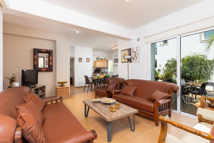 Open-plan living room with sofas, dining area, kitchen, A/C, WiFi internet, and satellite TV . - Villa Kalliopi . (Photo Gallery) }}