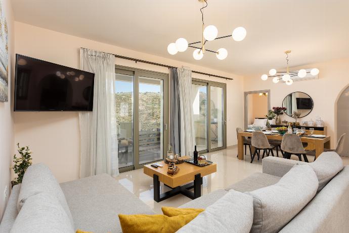 Open-plan living room with sofa, dining area, kitchen, A/C, WiFi internet, and satellite TV . - Villa Marielia . (Photo Gallery) }}