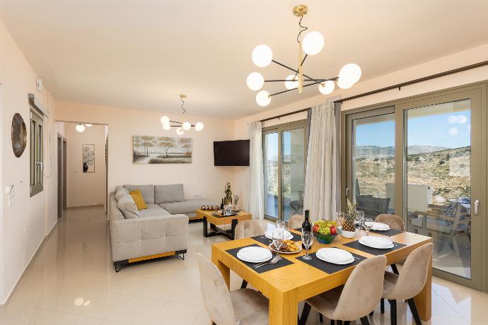 Open-plan living room with sofa, dining area, kitchen, A/C, WiFi internet, and satellite TV . - Villa Marielia . (Photo Gallery) }}